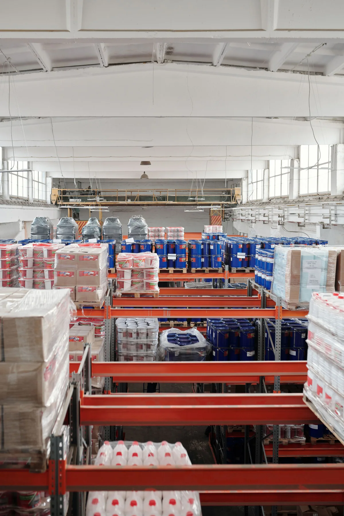 Pallet racks holding organized goods in a warehouse aisle.